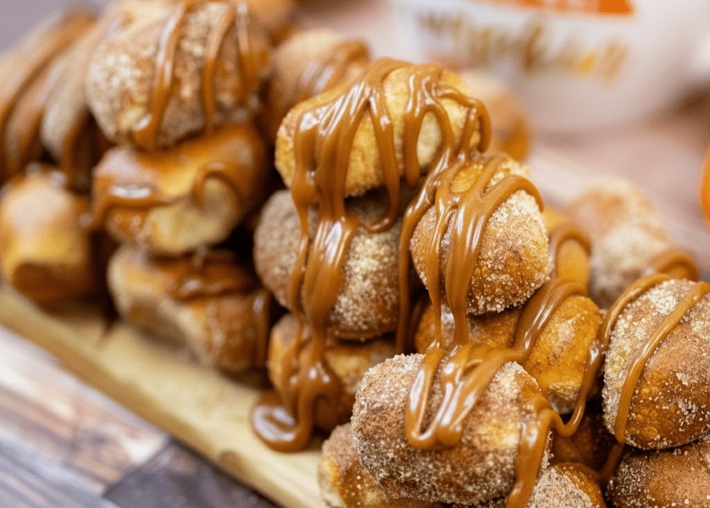 Pretzel Nuggets with caramel drizzle on a wooden board with a blurred background